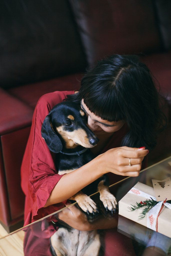 Woman snuggling with dog