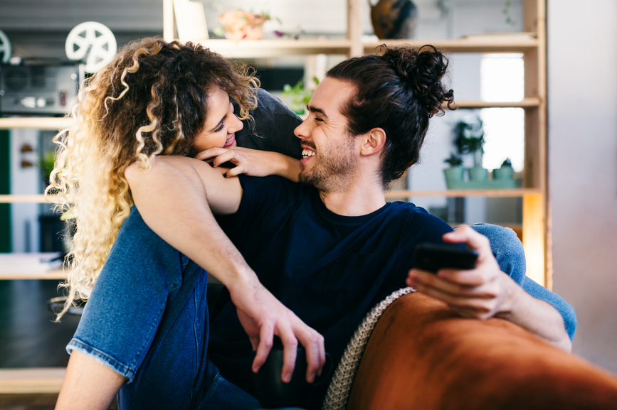 Young couple at home on sofa